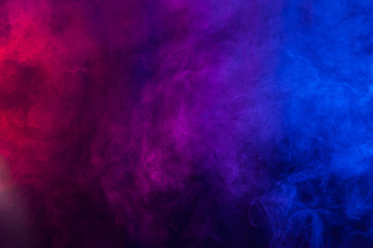 Violet and blue smoke or flame texture on a black background. Texture and abstract art