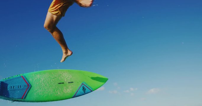 Kitesurfing at sunset in slow motion, kiteboarder gets big air