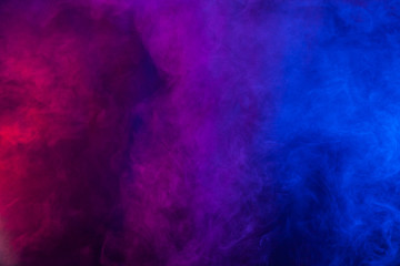 Obraz na płótnie Canvas Violet and blue smoke or flame texture on a black background. Texture and abstract art