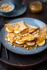 Pancakes with honey, bananas and pine nuts