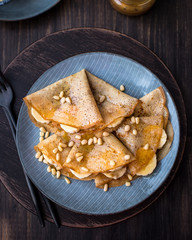 Pancakes with honey, bananas and pine nuts