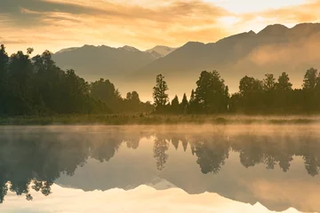 Gordijnen Beautiful mirror water Matheson lake in morning, New Zealand natural landscape background © pranodhm