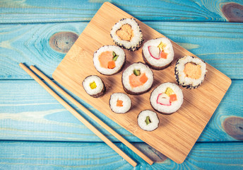 Various kinds of sushi on the blue background.