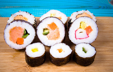 Various kinds of sushi on the blue background.