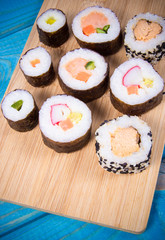 Various kinds of sushi on the blue background.