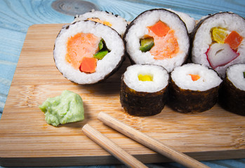 Various kinds of sushi on the blue background.