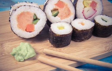 Various kinds of sushi on the blue background.