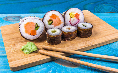 Various kinds of sushi on the blue background.
