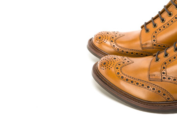 Premium Leather Tanned Brogue Boots Toes Closeup. Isolated Over White Background.