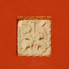 Old medieval byzantine relief with birds and animals on a wall in Venice