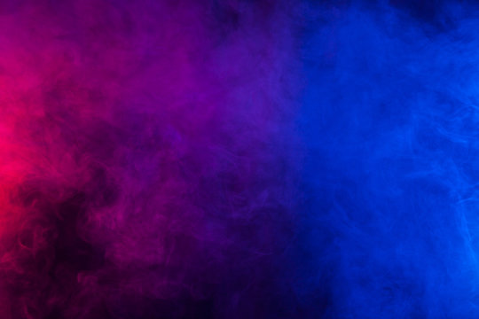 Violet and blue smoke on a black background. Texture and desktop arts