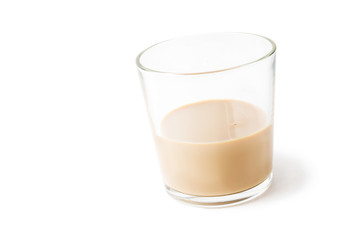 slanted glass tumbler with cream liqueur isolated on white