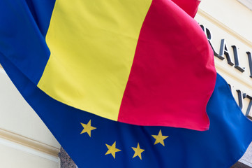 Flag of the European Union covered with the Romanian flag. Political relations and union concept....