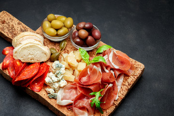 Italian prosciutto crudo or spanish jamon, cheese, olives and bread