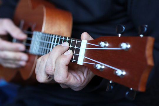 close up ukulele in musician hands