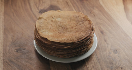 stack of fresh pancakes on wooden table