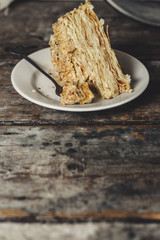 cake - Napoleon (puff cake with white cream) on a wooden table