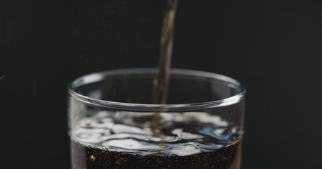 closeup cola pouring into glass