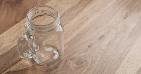 glass jar with handle on wood table