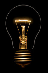 Photo of silhouette of incandescent filament bulbs on a black background. Detail of a lit European bulb. Product photo flashbulb.