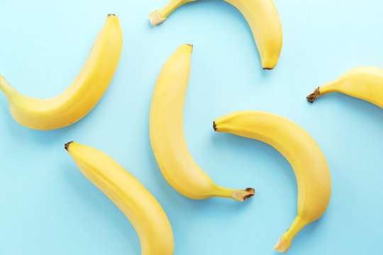 Yummy ripe bananas on color background