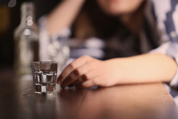 Woman with glass of alcohol in bar