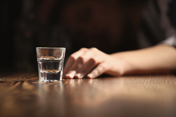 Woman with glass of alcohol in bar