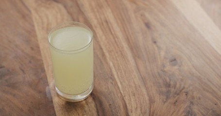 effervescent tablet in glass of water on wood table