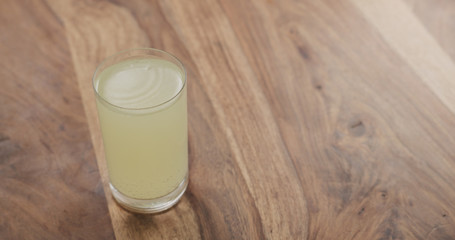 effervescent tablet in glass of water on wood table