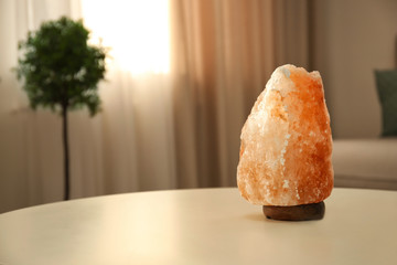 Himalayan salt lamp on table indoors