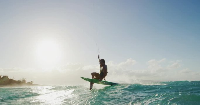 Kitesurfing at sunset in slow motion, summer fun extreme sport