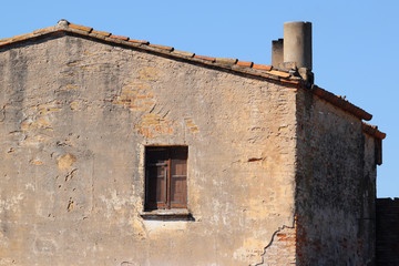 Damaged facade of a rural house used as a farmhouse tourism. Empty copy space for Editor's text.