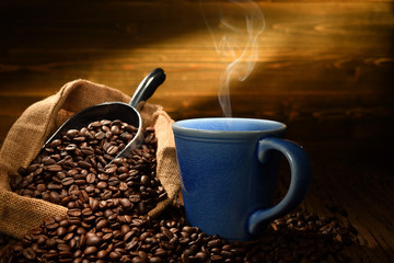 Cup of coffee with smoke on old wooden background