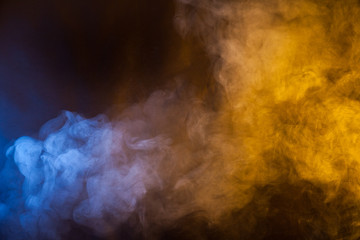 Blue and yellow smoke texture on a black background. Texture and abstract art - obrazy, fototapety, plakaty