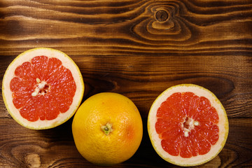 Fototapeta na wymiar Ripe fresh grapefruits on wooden table
