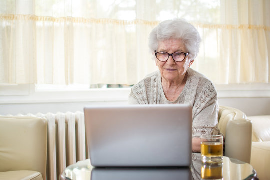 Senior woman using laptop at home.