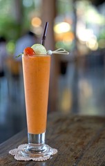 Fresh mixed tropical vegetable and fruit smoothie juice decorated with  fresh tomato and pice of lime
