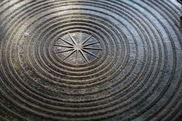 Surface of ancient magnificent bronze drum, Frog drum or Rain drum in Thailand. Circular line texture background
