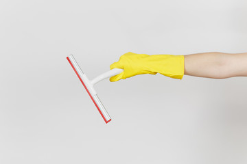Close up of female hand in yellow gloves horizontal holds white squeegee for surface cleaning with...