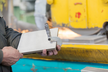 Factory workshop worker measure steel detail with caliper micrometer tool during finishing metal...