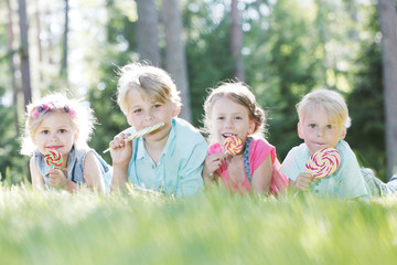 Happy children with lollipops