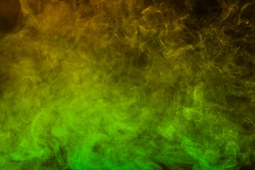 Obraz na płótnie Canvas Green and yellow smoke texture on a black background. Texture and abstract art