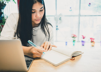 Young woman working with laptop in the office.
