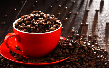 Composition with red cup of coffee and beans