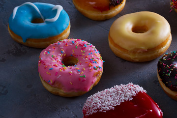sweet doughnuts on gray stone background