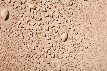 Colored water droplets on a gold background. Abstract liquid sprays