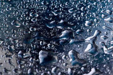 Colored water droplets on a gold background. Abstract liquid sprays