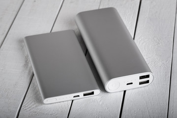 battery bank for charging mobile devices. Silver smart phone charger with power bank. External...