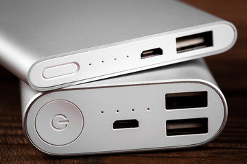 battery bank for charging mobile devices. Silver smart phone charger with power bank. External battery for mobile devices.