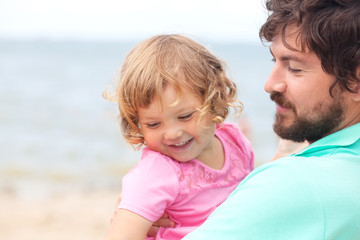 Father and daughter having fun at the beach.